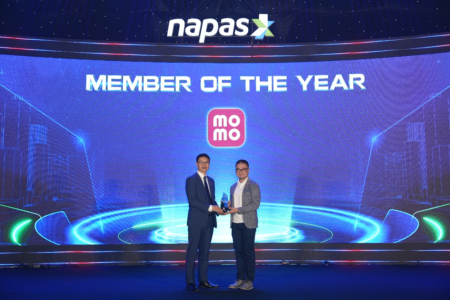 Two men holding an award  AI-generated content may be incorrect.